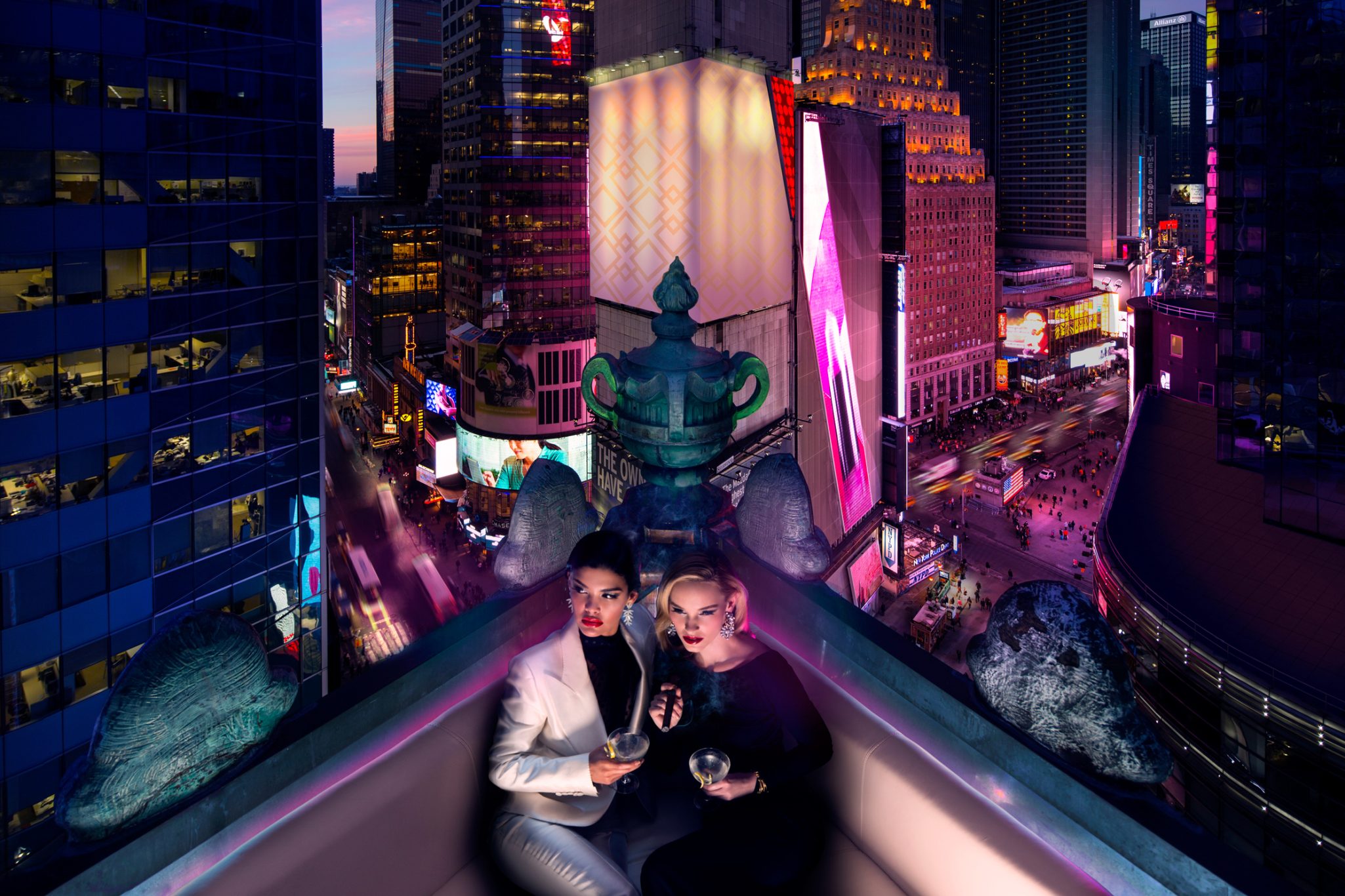 two women drinking cocktails on a rooftop bar