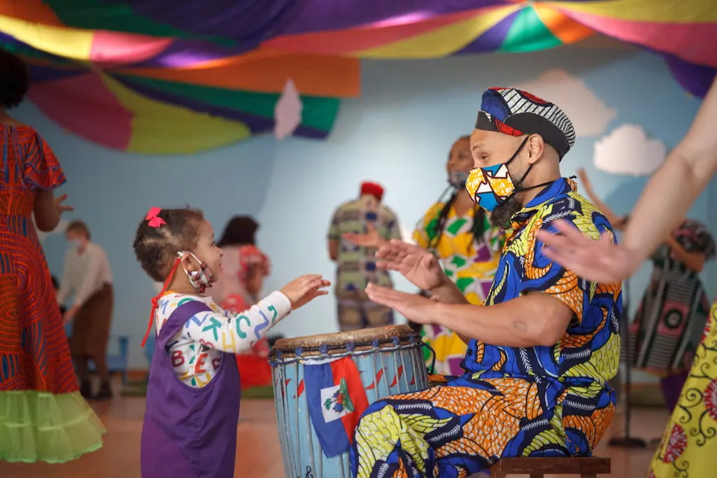 man playing drums with a child at the black future festival