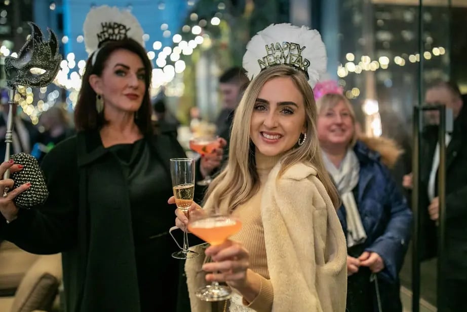 two people posing for a photograph on new years eve