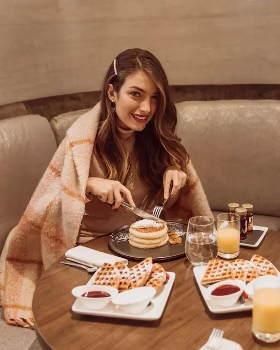 woman eating waffles and pancakes