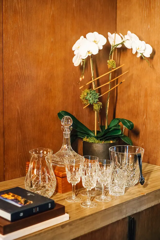 table with crystal dishes and an orchid