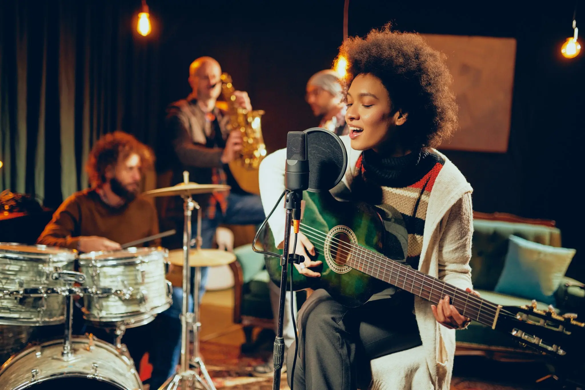 woman singing and playing a guitar