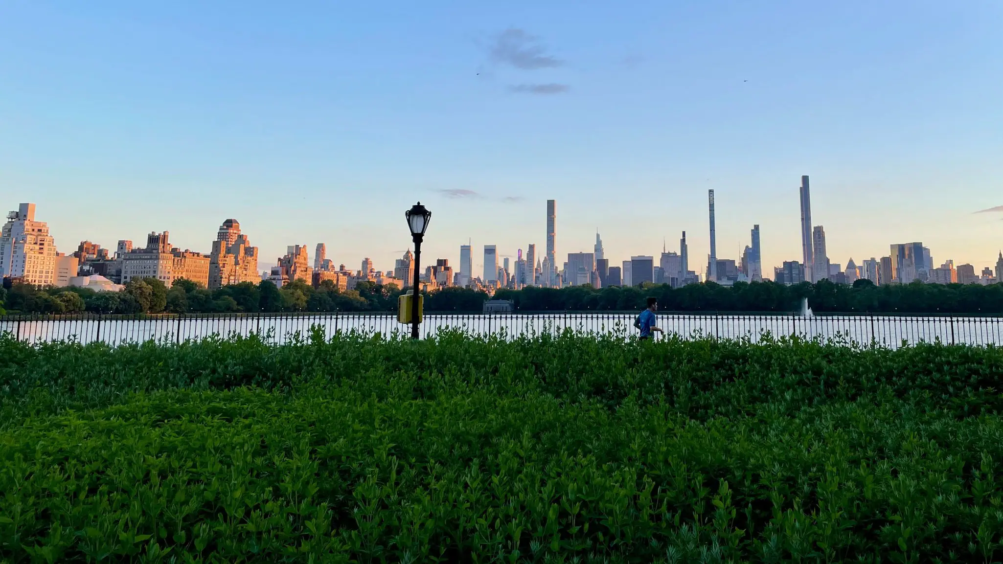 man running with NYC in the distance