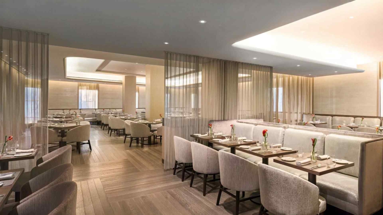 A well-lit, modern dining area with booths and tables set for meals.