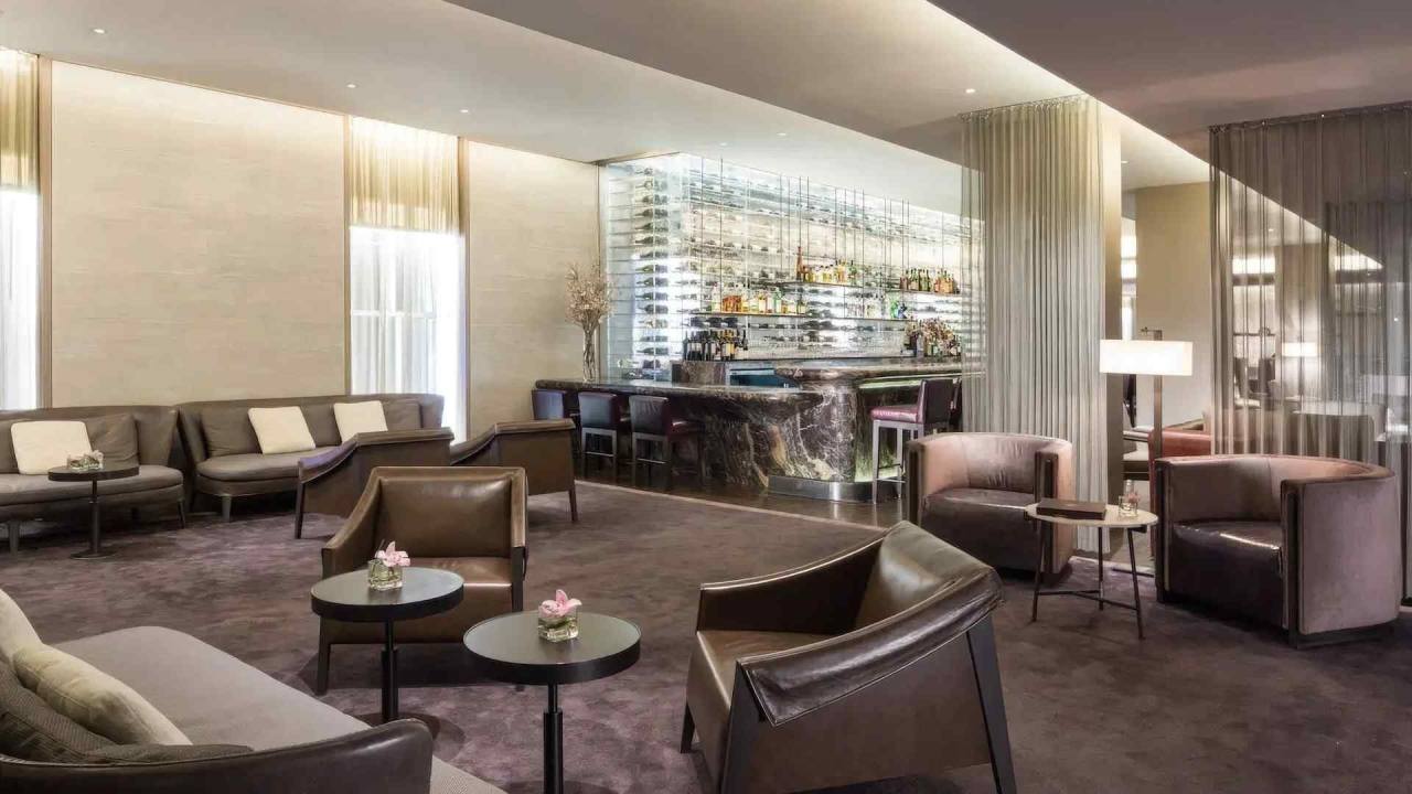 A luxurious lobby with a seating area, a bar, and a modern interior design.