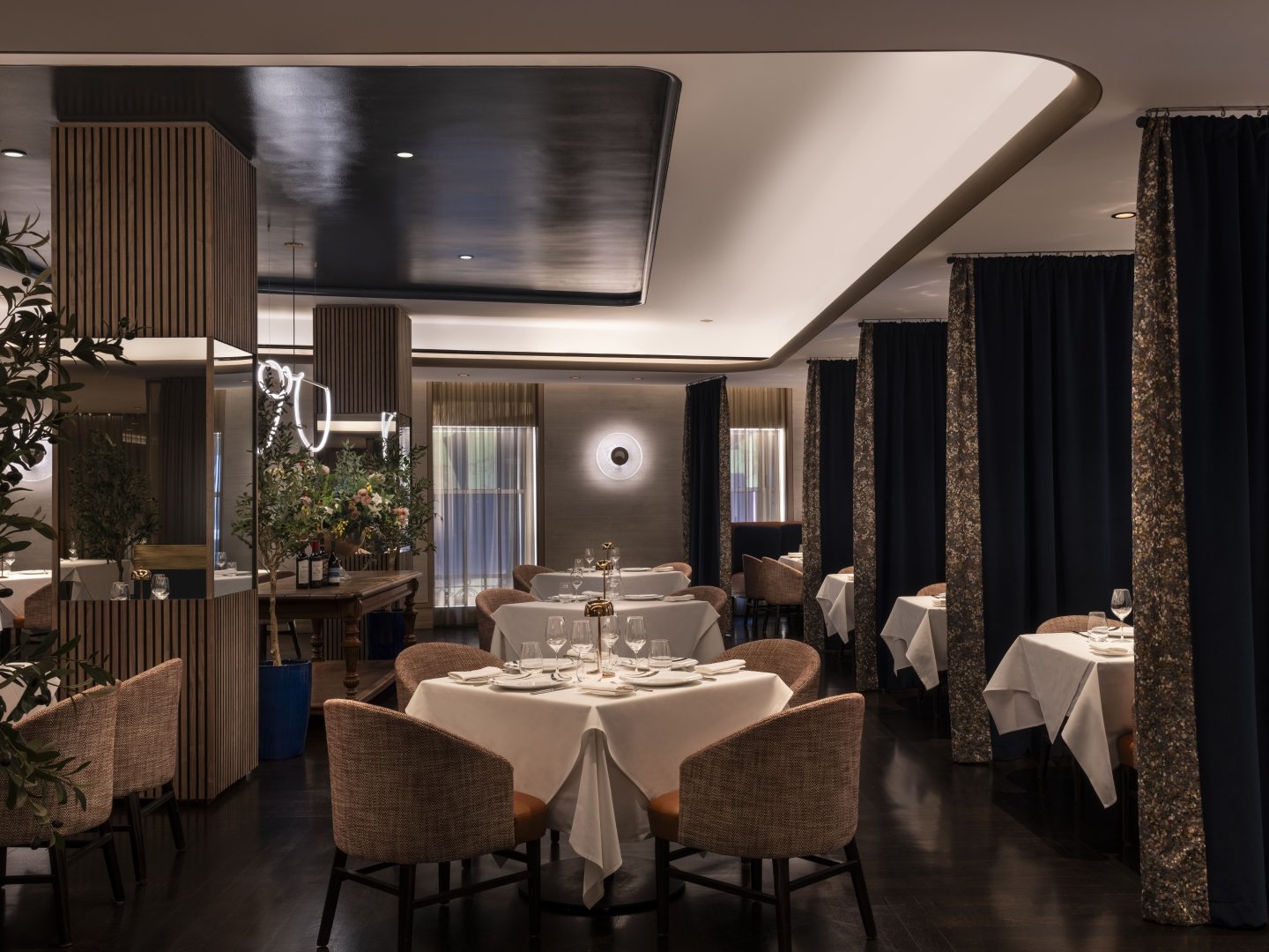 Interior of Charlie Palmer Steak IV showing dining tables and booths